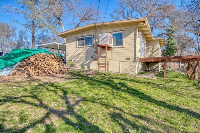 rear view of house with a yard