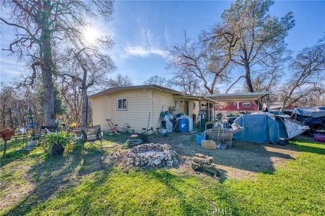 rear view of house featuring a lawn