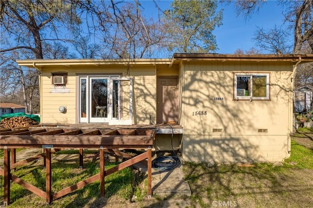 rear view of property with a wall mounted AC