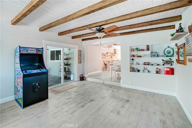 living room with beamed ceiling, ceiling fan, wood ceiling, and light hardwood / wood-style floors