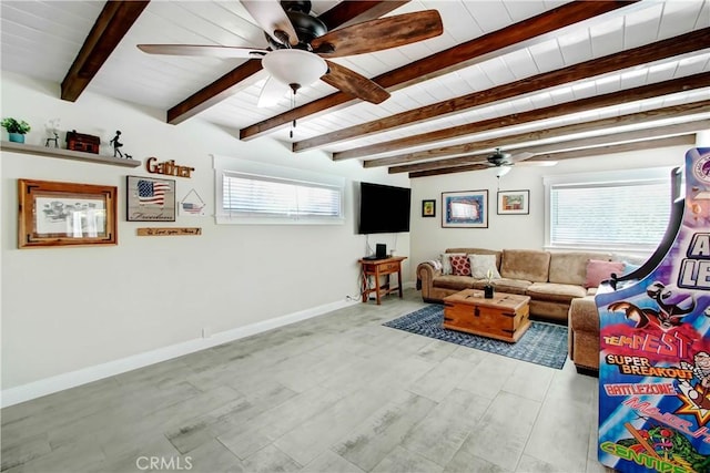 living room with beamed ceiling, wood ceiling, ceiling fan, and light hardwood / wood-style floors