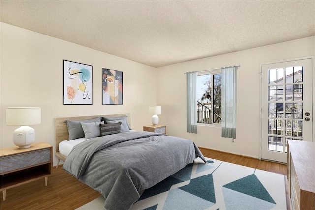 bedroom with hardwood / wood-style floors and a textured ceiling