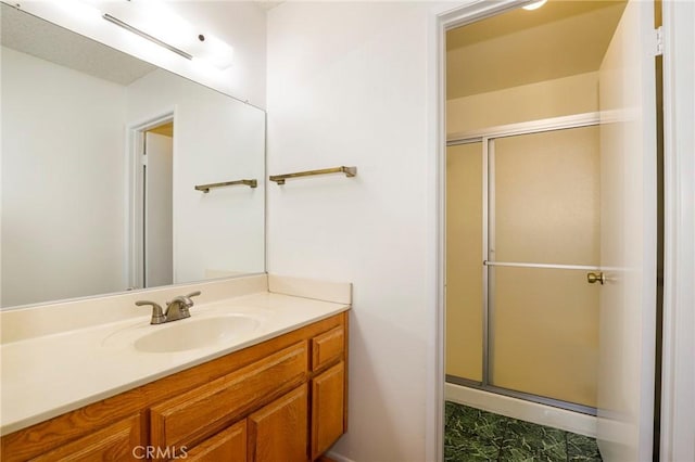 bathroom with vanity and a shower with door