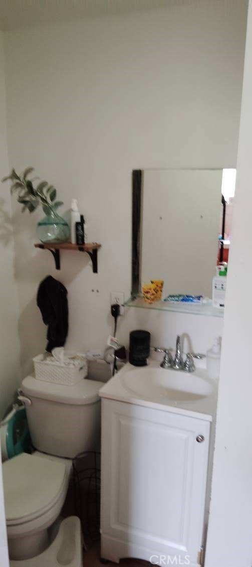 bathroom featuring vanity and toilet