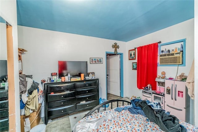 bedroom featuring light tile patterned flooring and an AC wall unit