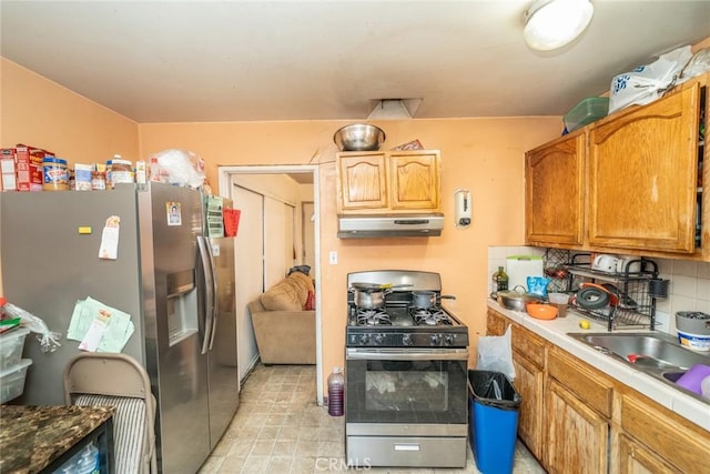 kitchen featuring stainless steel appliances, sink, and decorative backsplash