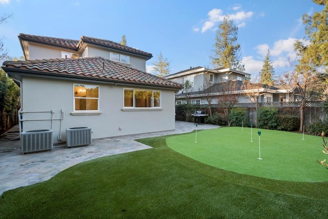 rear view of house with cooling unit and a patio area