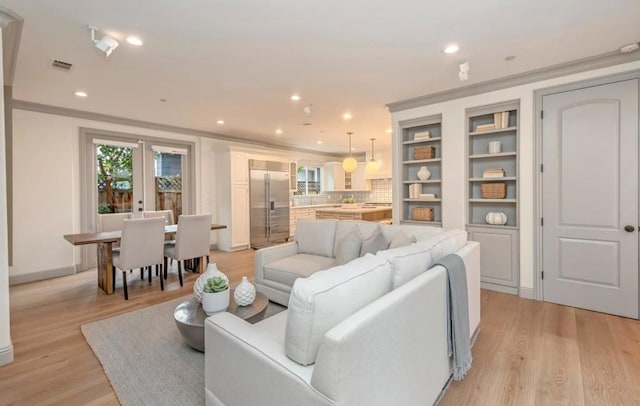 living room with light hardwood / wood-style floors and french doors