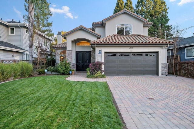 mediterranean / spanish house with french doors, a garage, and a front yard