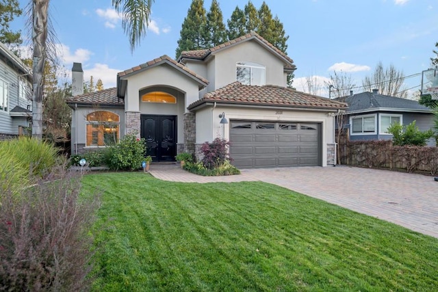 mediterranean / spanish-style home featuring french doors, a garage, and a front lawn