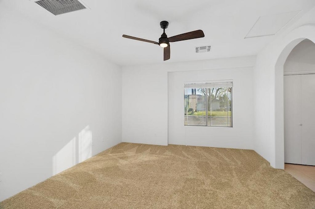 carpeted spare room with ceiling fan