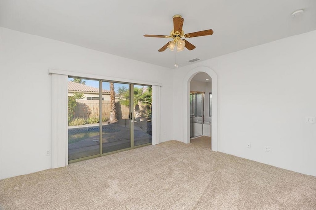 carpeted empty room featuring ceiling fan