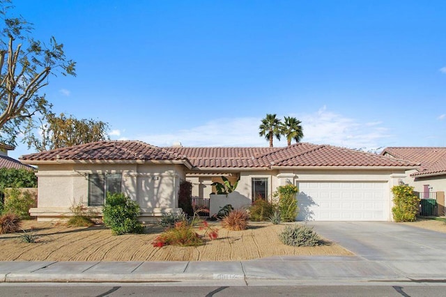 mediterranean / spanish-style house featuring a garage and cooling unit