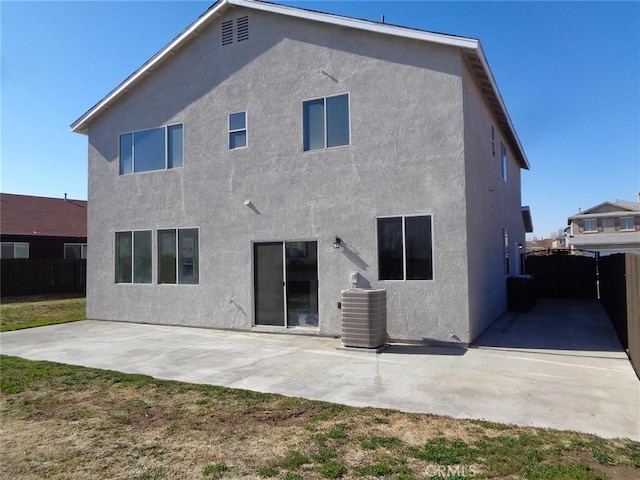 back of property with a patio and central AC unit