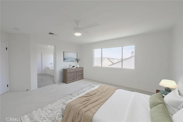 carpeted bedroom with connected bathroom and ceiling fan