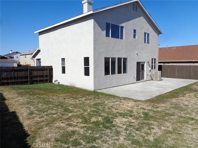 back of house featuring a yard, a patio, and central air condition unit