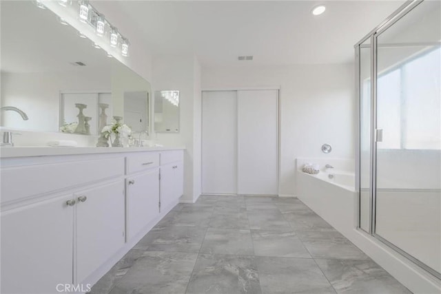 bathroom with vanity and plus walk in shower