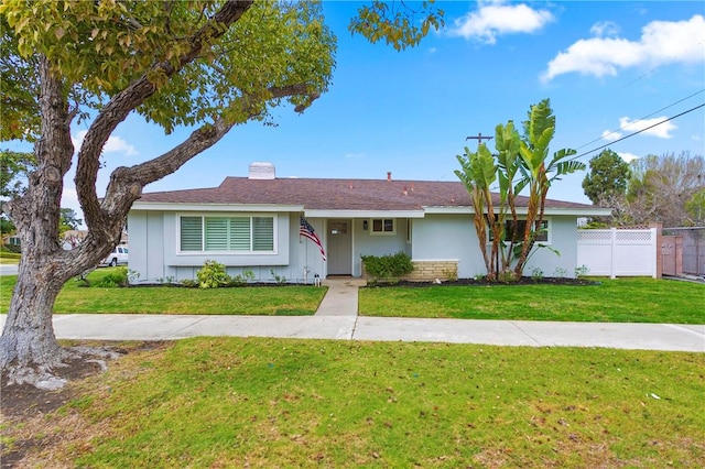 ranch-style home with a front lawn