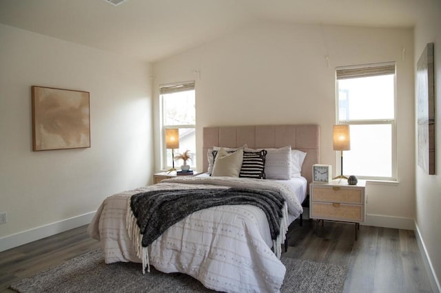 bedroom with dark wood-type flooring and vaulted ceiling