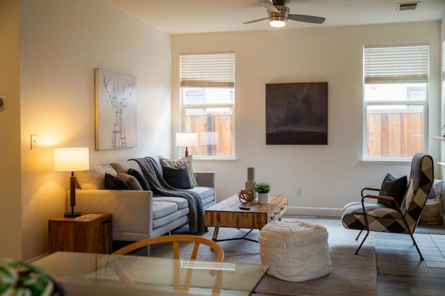 living room featuring ceiling fan and hardwood / wood-style floors