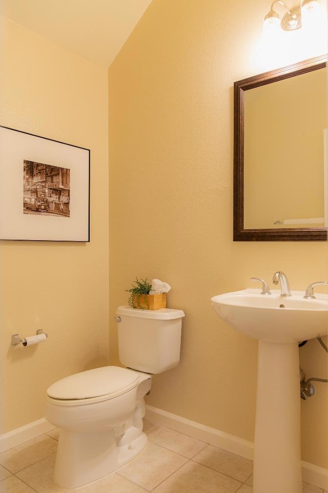 bathroom featuring tile patterned flooring, sink, and toilet