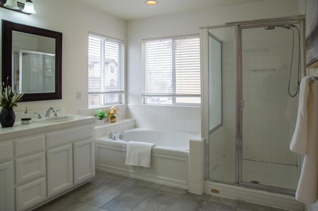 bathroom with vanity, tile patterned flooring, a wealth of natural light, and plus walk in shower