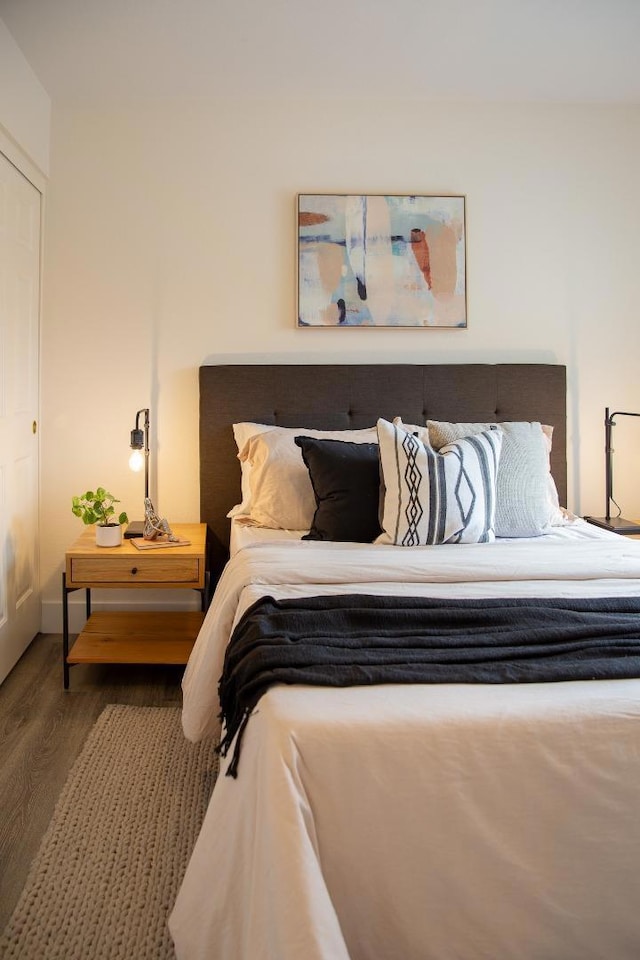 bedroom with dark wood-type flooring