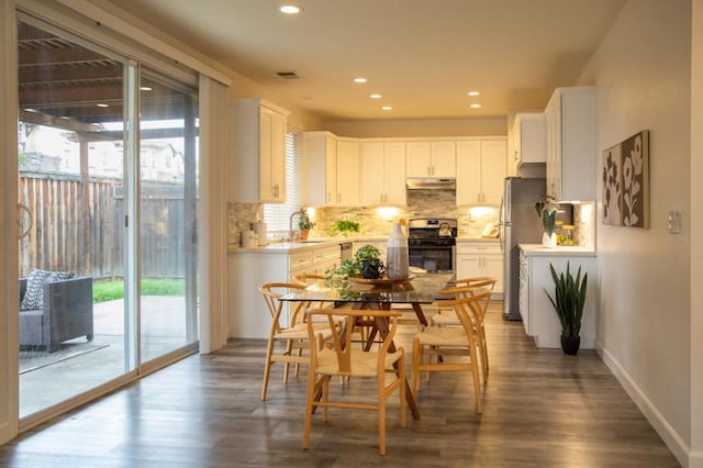 kitchen with backsplash, appliances with stainless steel finishes, sink, and white cabinets