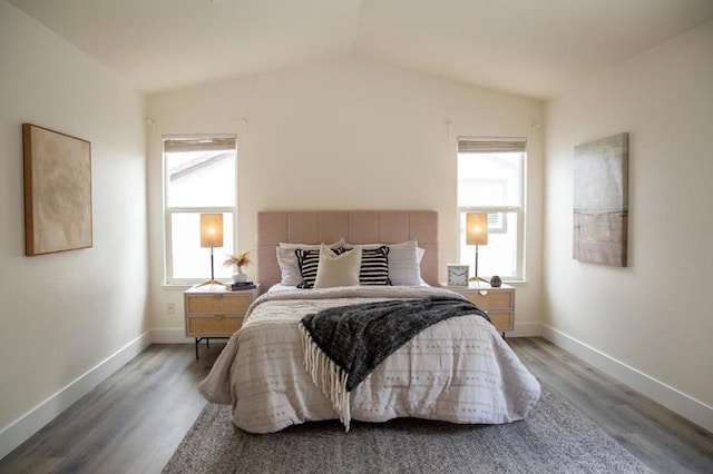 bedroom featuring lofted ceiling and hardwood / wood-style floors