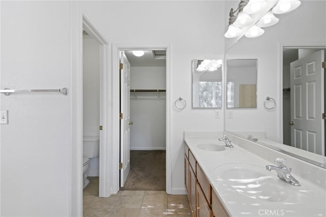 bathroom with vanity, tile patterned flooring, and toilet