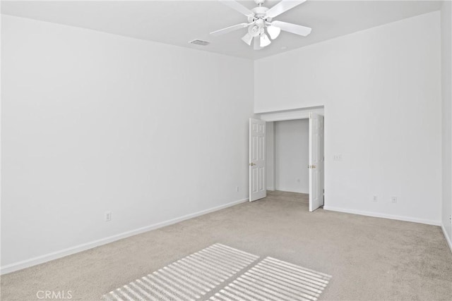 unfurnished room with ceiling fan and light colored carpet