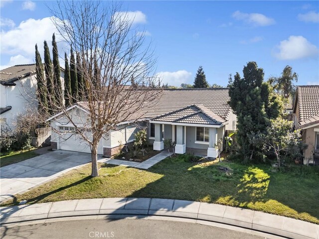 view of front of home featuring a garage and a front lawn