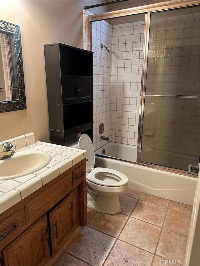 full bathroom featuring toilet, vanity, enclosed tub / shower combo, and tile patterned flooring