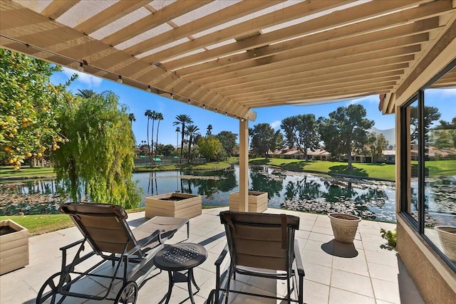 view of patio with a water view and a pergola