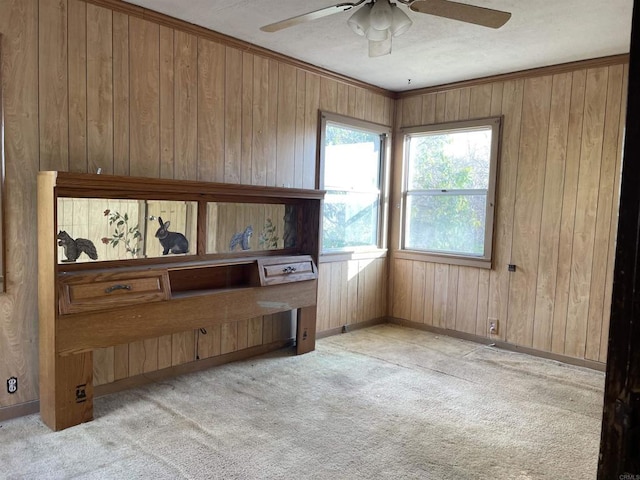 miscellaneous room with light carpet, wooden walls, and ceiling fan