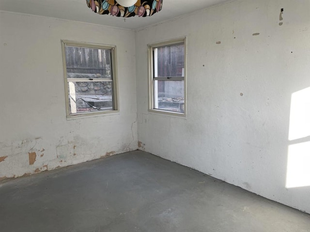 unfurnished room featuring concrete floors