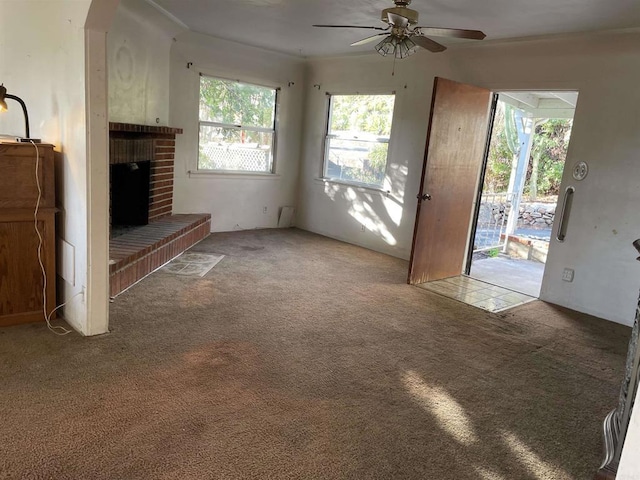 unfurnished living room featuring ceiling fan, a fireplace, and carpet floors