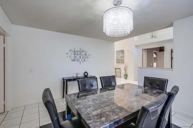 dining area with a fireplace, light tile patterned floors, and a notable chandelier