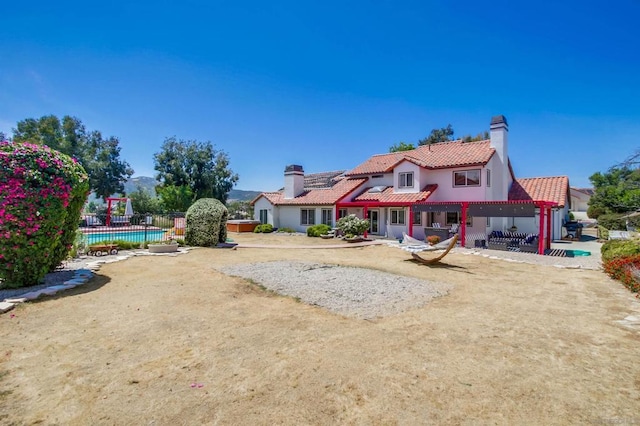 back of house featuring a swimming pool