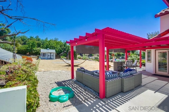 view of patio / terrace featuring an outdoor living space, a pergola, and a storage shed