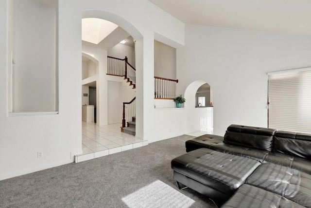 living room featuring light carpet and a high ceiling