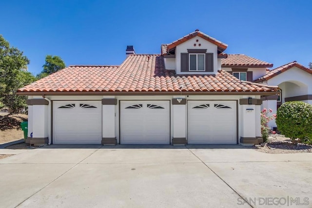 mediterranean / spanish-style house featuring a garage