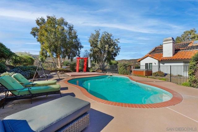 view of swimming pool with a patio