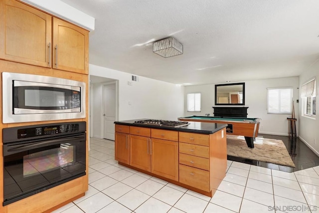 kitchen with stainless steel appliances, light tile patterned floors, and billiards