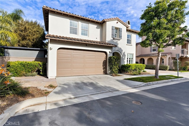 mediterranean / spanish house with a garage