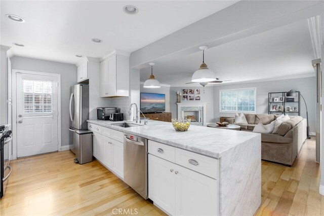 3140 Sumatra Pl, Costa Mesa, CA 92626 - kitchen featuring appliances with stainless steel finishes, a sink, a peninsula, healthy amount of natural light, and recessed lighting