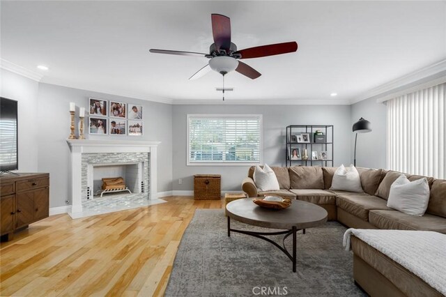 3140 Sumatra Pl, Costa Mesa, CA 92626 - living room with light wood-style floors, a tiled fireplace, recessed lighting, a ceiling fan, and crown molding