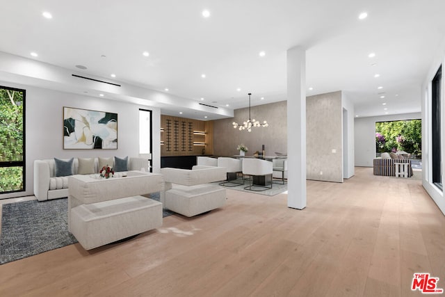 living room featuring an inviting chandelier and light hardwood / wood-style flooring