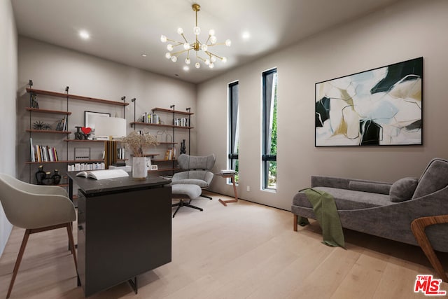 sitting room featuring light hardwood / wood-style floors and a notable chandelier