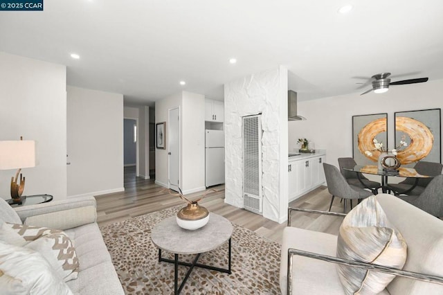 living room featuring ceiling fan and light wood-type flooring